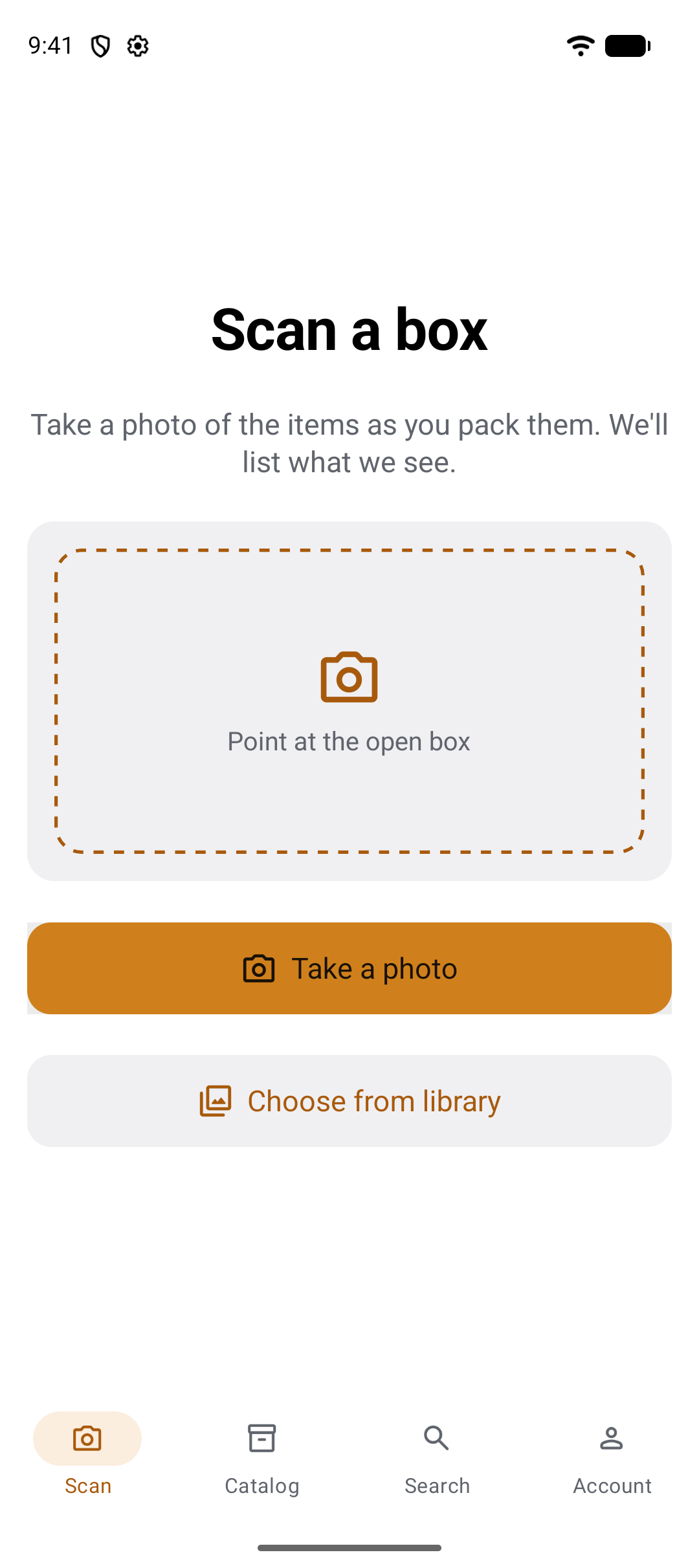 The Scan tab: the title Scan a box, the line Take a photo of the items as you pack them, we'll list what we see, a dashed viewfinder reading Point at the open box, and the buttons Take a photo and Choose from library.